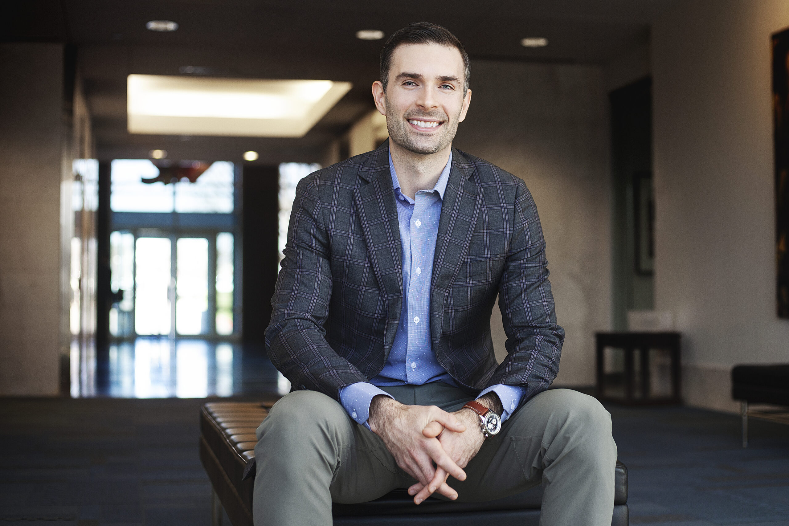 Headshot of Joel outside with his arms crossed